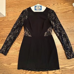 Long sleeve black mini dress with glittery lace detailing. Size 4. Worn once